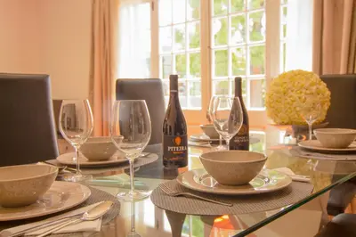 a dining room table with wine bottles and glasses at Pilar House in Funchal