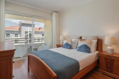 a bedroom with a large bed and a balcony at Ajuda IV by An Island Apart in Funchal