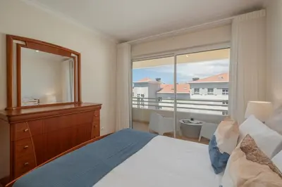 a bedroom with a bed and a mirror and a balcony at Ajuda IV by An Island Apart in Funchal
