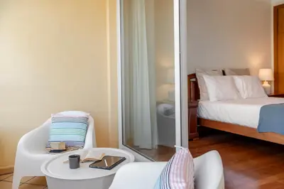 a small room with a bed and a mirror at Ajuda IV by An Island Apart in Funchal