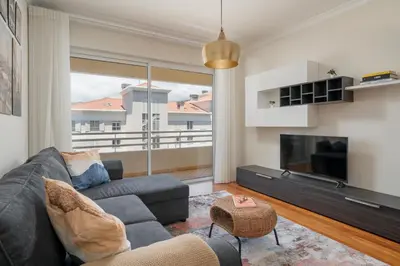 a living room with a couch and a tv at Ajuda IV by An Island Apart in Funchal
