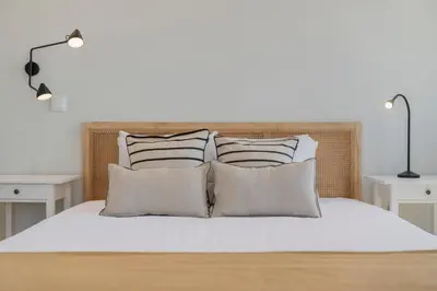 a bed with four pillows and a headboard at Casa da Amoreira by An Island Apart in Funchal