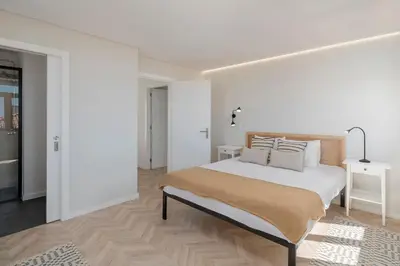 a white bedroom with a large bed with pillows at Casa da Amoreira by An Island Apart in Funchal