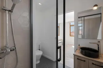 a bathroom with a sink and a toilet and a mirror at Casa da Amoreira by An Island Apart in Funchal