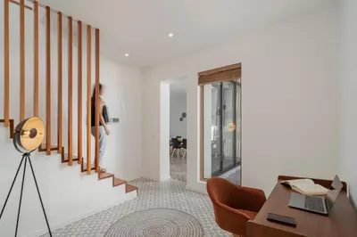 a woman walking down the stairs in a house at Casa da Amoreira by An Island Apart in Funchal