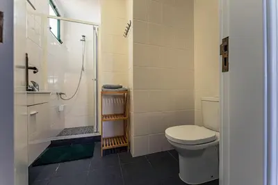 a bathroom with a toilet and a shower at Melro's Place by Stay Madeira in Ponta do Sol