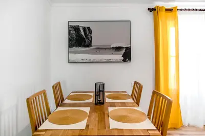a dining room table with four chairs and a blender on it at Mola Mola Sagres in Sagres