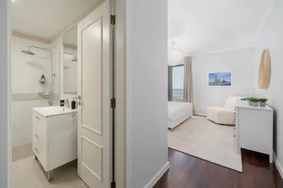 a white bathroom with a sink and a mirror at Caniço VII by An Island Apart in Santa Cruz