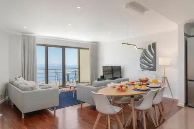 a living room with a table and chairs at Caniço VII by An Island Apart in Santa Cruz