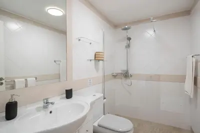 a bathroom with a sink and a toilet and a shower at Caniço VII by An Island Apart in Santa Cruz