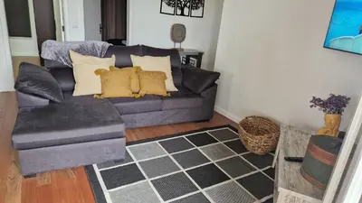 a living room with a couch and a chair at Vila Henrique Country Cottage in Fajã da Ovelha