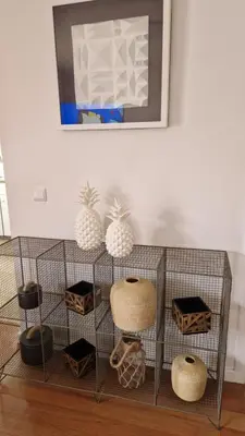 a shelf with vases and other items in a room at Vila Henrique Country Cottage in Fajã da Ovelha