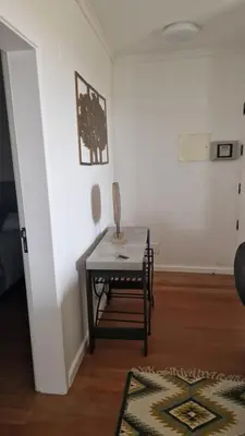 a room with a table and a chair in a room at Vila Henrique Country Cottage in Fajã da Ovelha