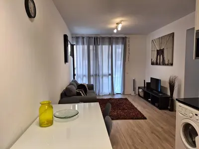 a living room with a white table and a couch at Laser Pedra de Abreu in Funchal