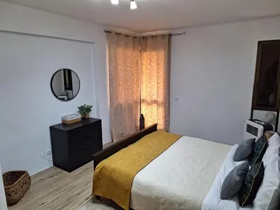 a bedroom with a large bed and a mirror at Laser Pedra de Abreu in Funchal