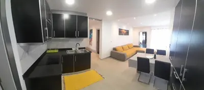 a kitchen and living room with a couch and a table at Santo Relaxium in Ponta do Sol