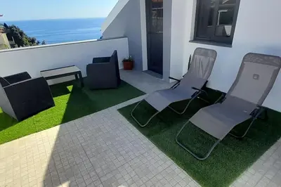 two chairs and a table on a balcony at SantoSerenus in Ponta do Sol