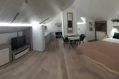 a bedroom with a bed and a table with chairs at SantoSerenus in Ponta do Sol