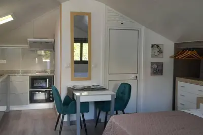 a kitchen with a table and chairs in a room at SantoSerenus in Ponta do Sol