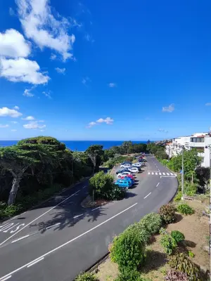 a street with cars parked on the side of a road at Machico Terrace in Machico