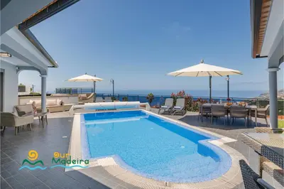 a swimming pool with a view of the ocean at OurMadeira - This Side of Paradise in Arco da Calheta