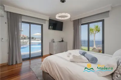 a bedroom with a bed with a view of the ocean at OurMadeira - This Side of Paradise in Arco da Calheta