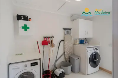 a kitchen with a washing machine and a refrigerator at OurMadeira - This Side of Paradise in Arco da Calheta