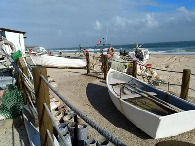 a boat is tied up on the beach at Casa Sereia Praia in Salema