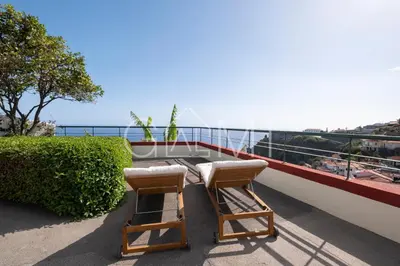 two chairs and a table on a balcony at Casa Vista Mar by GALMI in Calheta