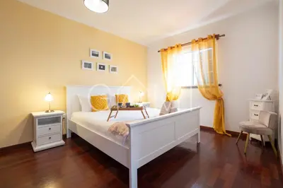 a bedroom with a white bed and a window at Casa Vista Mar by GALMI in Calheta