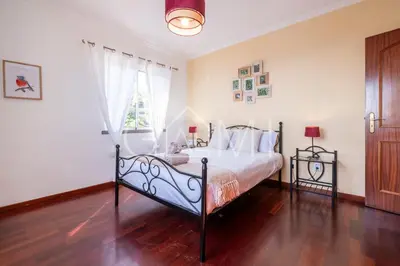a bedroom with a bed and a window at Casa Vista Mar by GALMI in Calheta