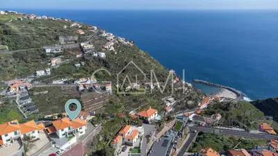 an aerial view of a town on a hill next to the ocean at Casa Vista Mar by GALMI in Calheta