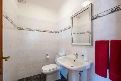 a white bathroom with a sink and a toilet at Casa Vista Mar by GALMI in Calheta