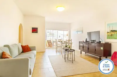 a living room with a couch and a tv at B68 - Luz Vista Mar Apartment in Luz