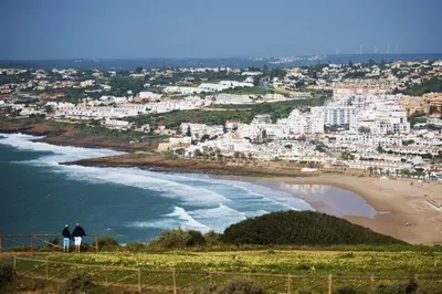 two people standing on a hill overlooking a beach at B68 - Luz Vista Mar Apartment in Luz