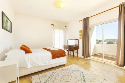 a bedroom with a bed and a desk and a window at B68 - Luz Vista Mar Apartment in Luz