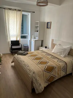 a bedroom with a bed and a chair and a window at Cc39 -Q1 in Funchal