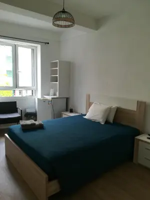 a bedroom with a large bed with a blue blanket at Cc39 -Q1 in Funchal