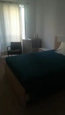 a bedroom with a large bed with a blue comforter at Cc39 -Q1 in Funchal