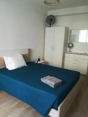 a bedroom with a large bed with a blue blanket at Cc39 -Q1 in Funchal
