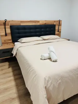 a bed with a pair of white socks on it at Paradise Garajau in Garajau