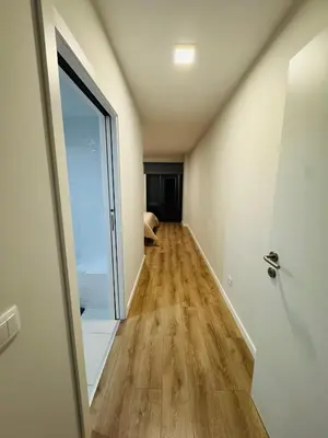 an empty hallway with a door and a window at Paradise Garajau in Garajau