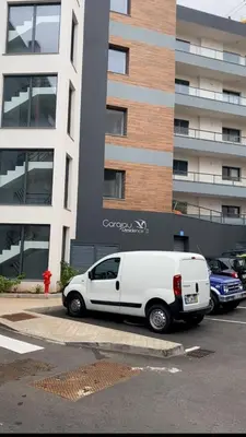 a white van parked in front of a building at Paradise Garajau in Garajau