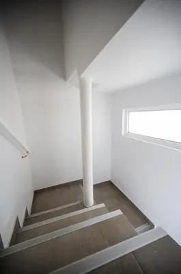 a white room with stairs and a window at Sweet Home Madeira in Camacha