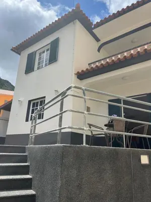 a house with stairs in front of it at Vivenda da Praia in Machico