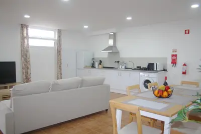 a living room with a couch and a table at Lugar dos Louros 2 in Estreito da Calheta