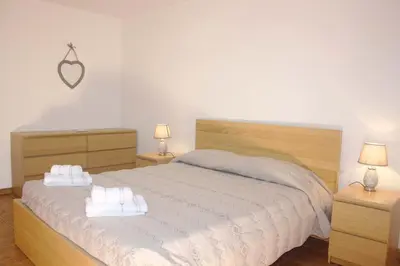 a bedroom with a bed with two towels on it at Lugar dos Louros 2 in Estreito da Calheta