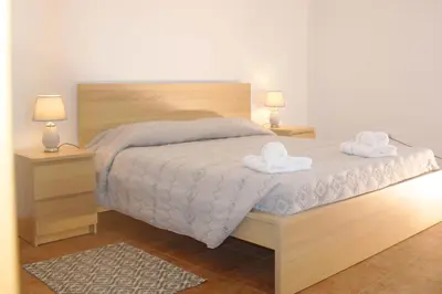 a bedroom with a bed with two towels on it at Lugar dos Louros 2 in Estreito da Calheta