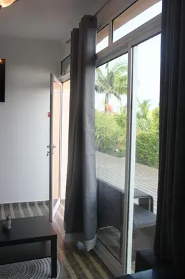 a room with a sliding glass door to a balcony at Lugar dos Louros 1 in Estreito da Calheta