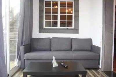 a living room with a couch and a coffee table at Lugar dos Louros 1 in Estreito da Calheta